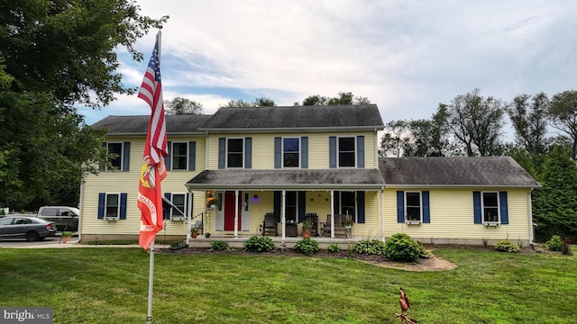 view of front of property featuring a front yard and covered porch