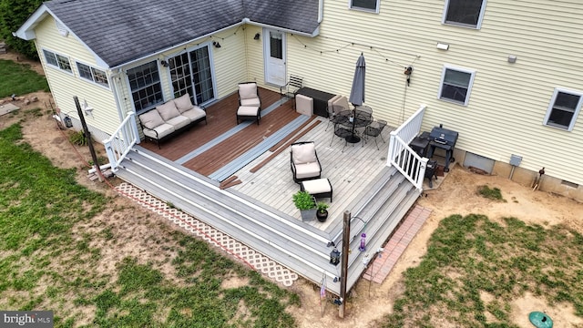 exterior space with an outdoor hangout area and a wooden deck