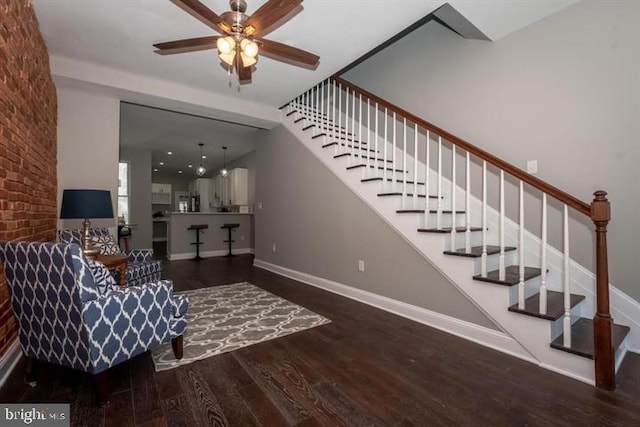 staircase featuring ceiling fan and wood-type flooring