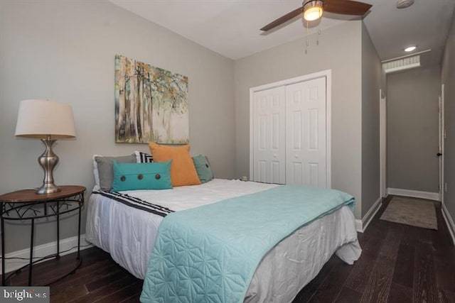 bedroom featuring a closet, dark hardwood / wood-style floors, and ceiling fan