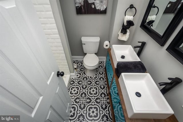 bathroom with toilet and tile patterned flooring