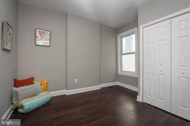 sitting room with dark hardwood / wood-style flooring