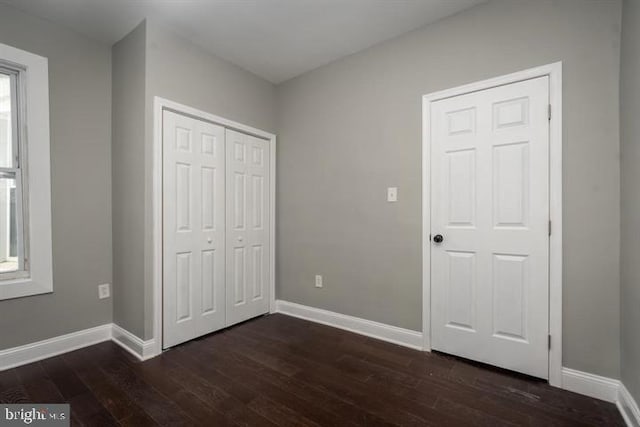 unfurnished bedroom featuring dark hardwood / wood-style floors