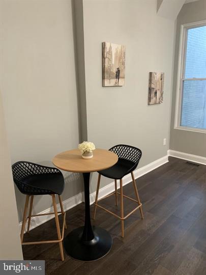 dining room with dark wood-type flooring