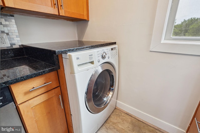 washroom featuring cabinets, light tile patterned flooring, and washer / dryer