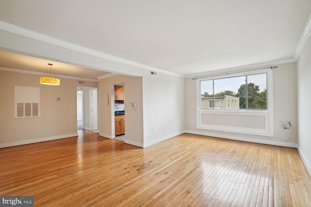 unfurnished living room featuring crown molding and light wood-type flooring