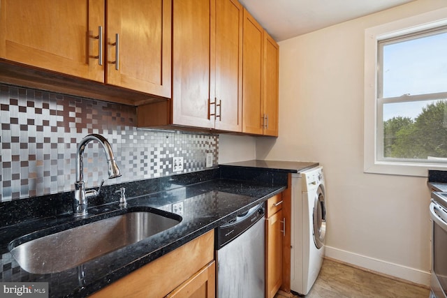 kitchen featuring dark stone countertops, stainless steel dishwasher, sink, and decorative backsplash