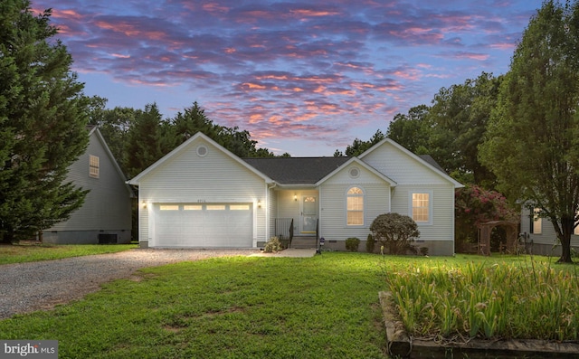 view of front of house featuring a garage and a lawn