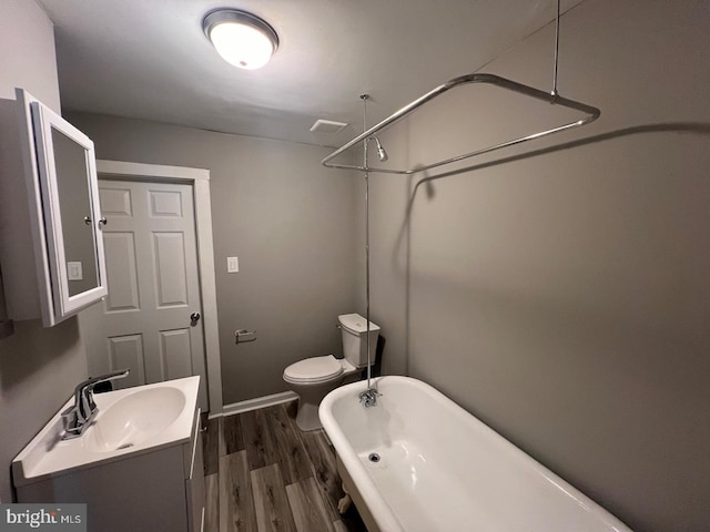 bathroom featuring hardwood / wood-style flooring, toilet, and vanity