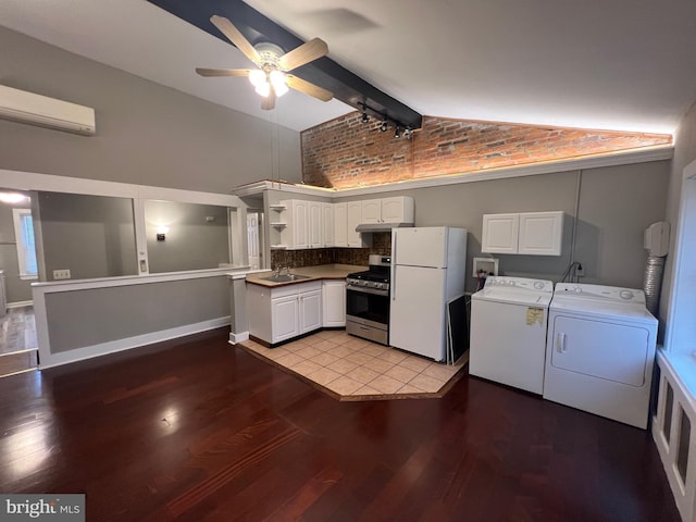 kitchen featuring a wall mounted AC, gas stove, white fridge, white cabinetry, and washer and clothes dryer