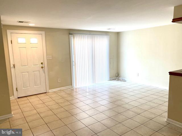 entrance foyer featuring light tile patterned floors and a wealth of natural light