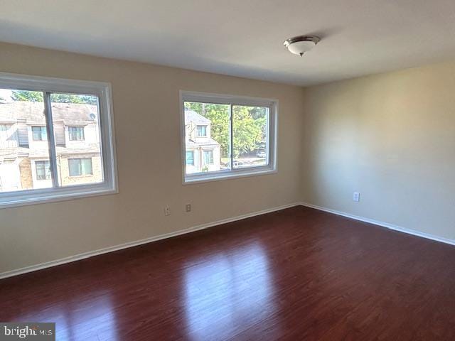 spare room with dark wood-type flooring