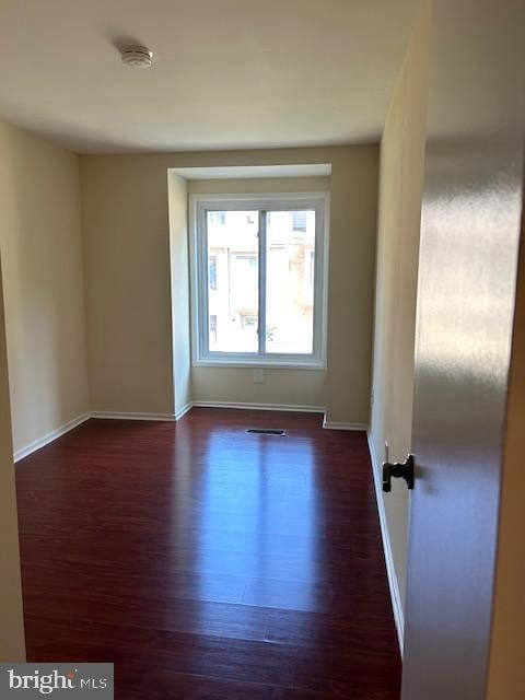 empty room featuring dark hardwood / wood-style floors