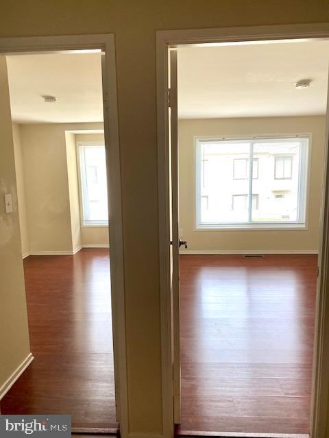 hall with dark wood-type flooring