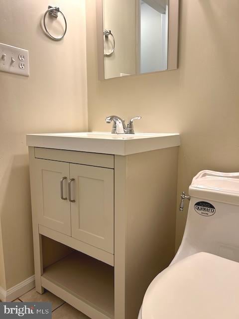 bathroom featuring vanity, toilet, and tile patterned flooring