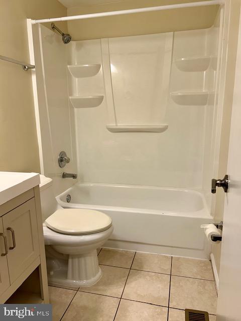 full bathroom with tile patterned flooring, vanity, shower / bath combination, and toilet