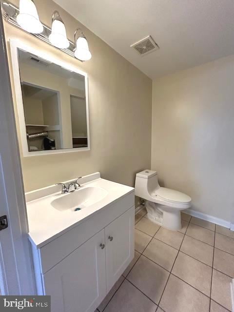 bathroom with vanity, tile patterned floors, and toilet