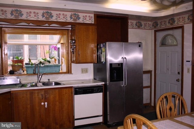 kitchen featuring stainless steel fridge, sink, and white dishwasher