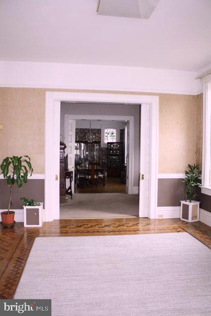 hallway featuring hardwood / wood-style floors and a chandelier