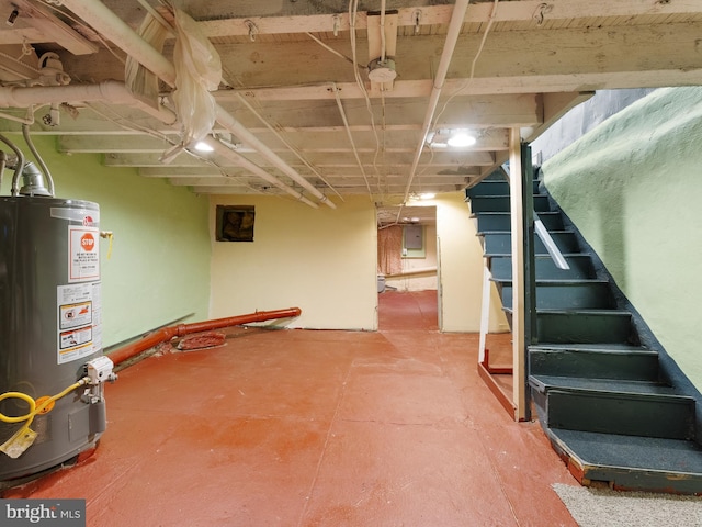 basement featuring electric panel and gas water heater