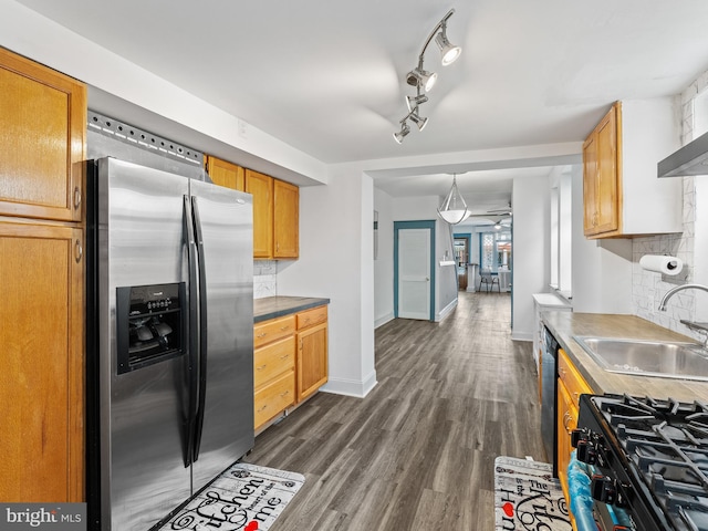 kitchen featuring dishwasher, gas stove, stainless steel refrigerator with ice dispenser, dark hardwood / wood-style flooring, and sink