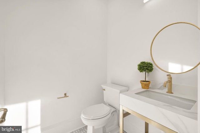 bathroom featuring toilet and vanity