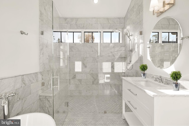 full bath with a stall shower, plenty of natural light, and vanity