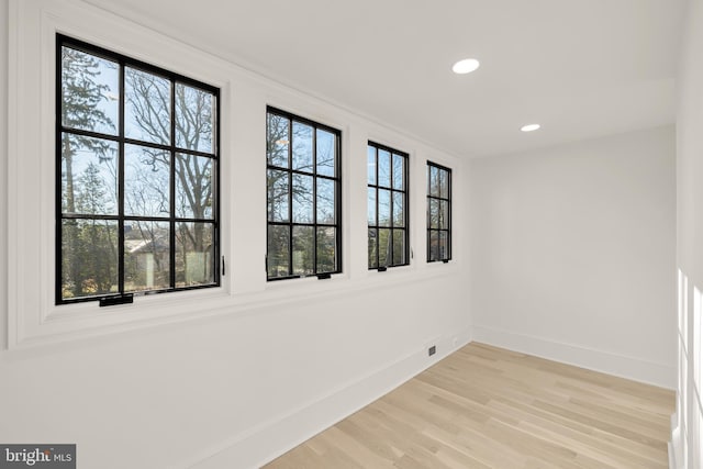 unfurnished room featuring light hardwood / wood-style floors