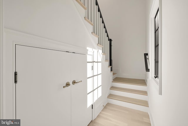 stairs featuring wood finished floors