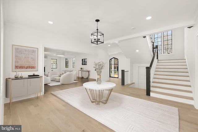 foyer featuring light wood-type flooring, stairway, a chandelier, and recessed lighting