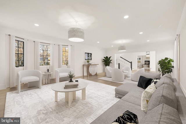 living room featuring baseboards, stairway, light wood-style flooring, and recessed lighting