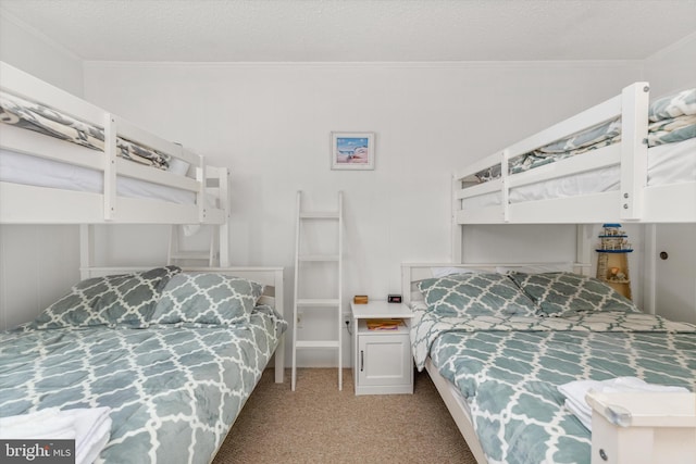 bedroom with crown molding, light carpet, and a textured ceiling