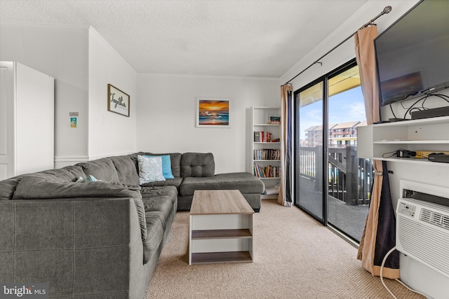 living room with light carpet, a wall unit AC, and a textured ceiling