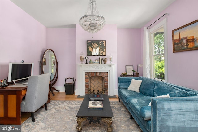 living room featuring a fireplace, a chandelier, and hardwood / wood-style floors