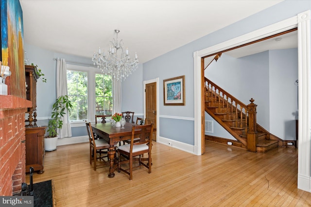 dining area with a chandelier and light wood-type flooring