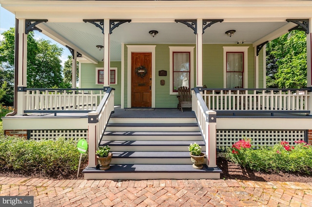 view of exterior entry with covered porch