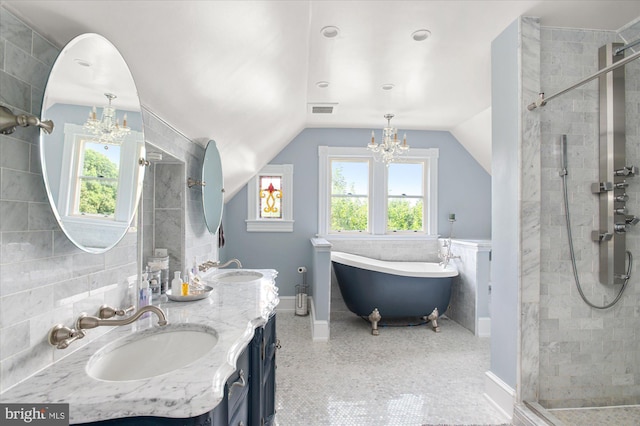 bathroom with plus walk in shower, dual vanity, lofted ceiling, and tile walls