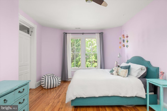 bedroom with ceiling fan and light wood-type flooring