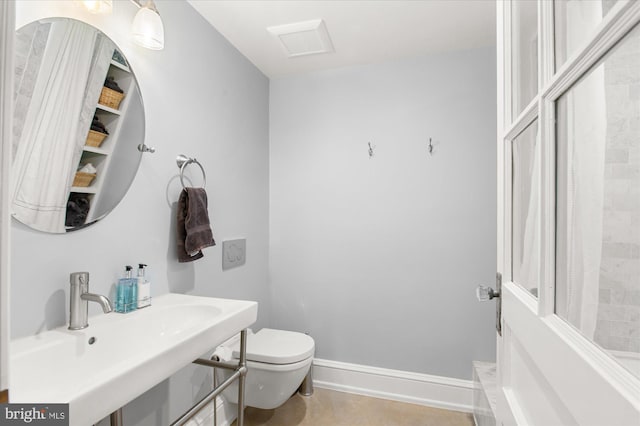 bathroom with sink, toilet, and tile patterned flooring