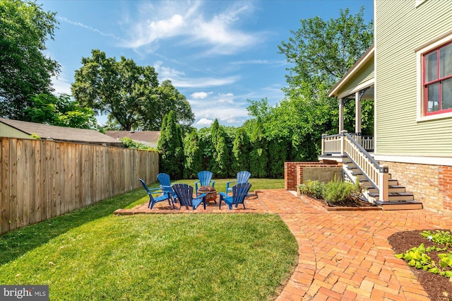 view of yard with a patio area and an outdoor fire pit