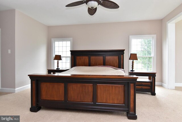 bedroom with light carpet and ceiling fan