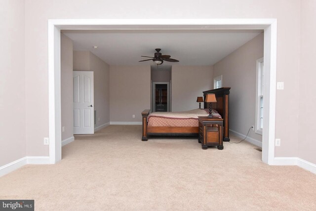 bedroom with ceiling fan and light colored carpet