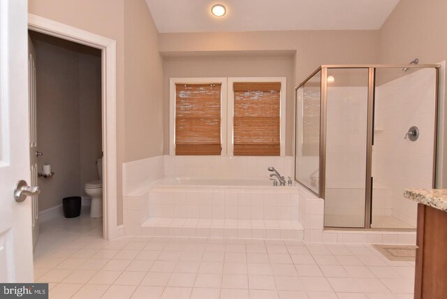 full bathroom with vanity, tile patterned flooring, toilet, and separate shower and tub