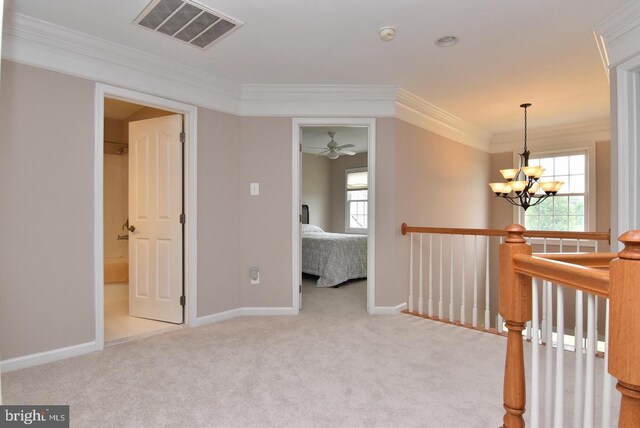 spare room featuring carpet floors, ceiling fan with notable chandelier, and ornamental molding