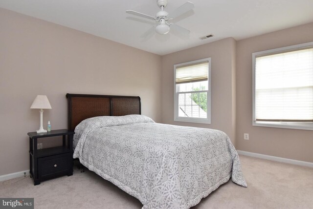 bedroom featuring ceiling fan and light colored carpet