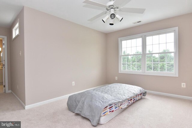 carpeted bedroom featuring ceiling fan