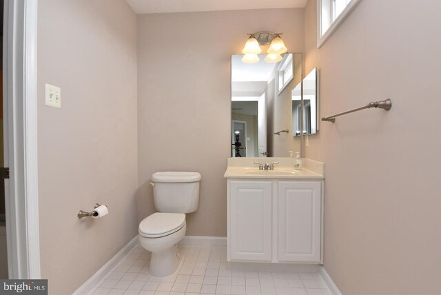 bathroom featuring vanity, tile patterned floors, and toilet