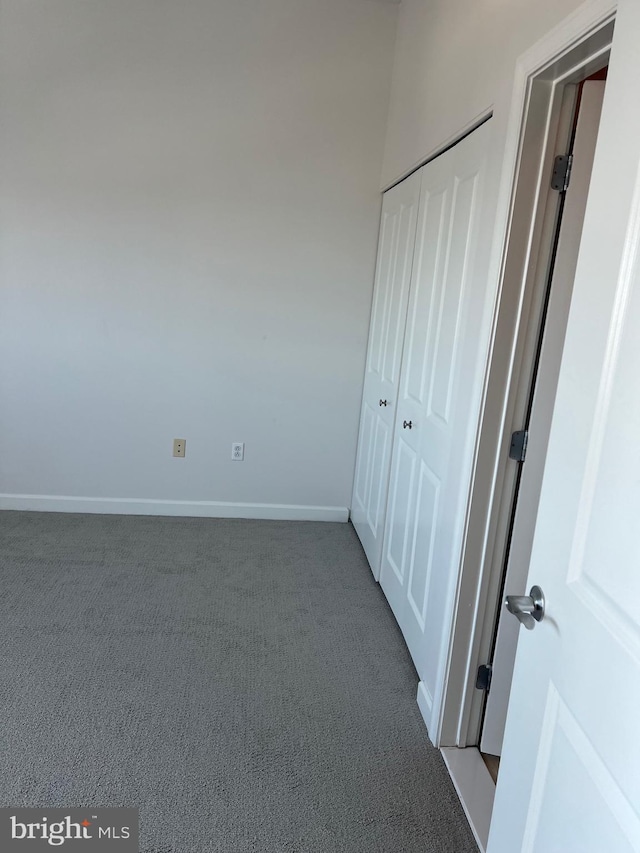 unfurnished bedroom featuring a closet and carpet flooring