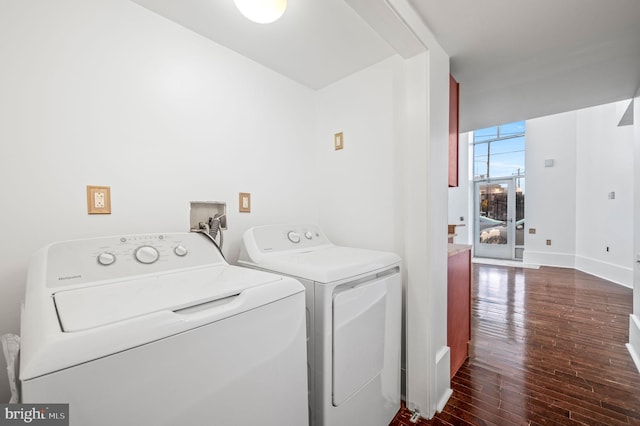 laundry room with independent washer and dryer and dark hardwood / wood-style floors