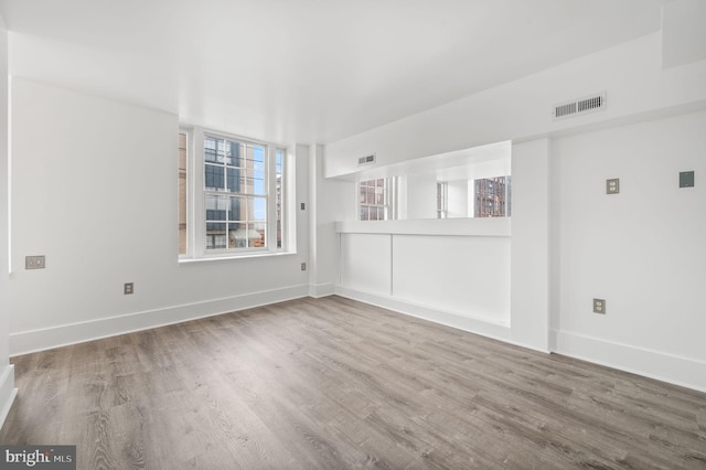 spare room with wood-type flooring